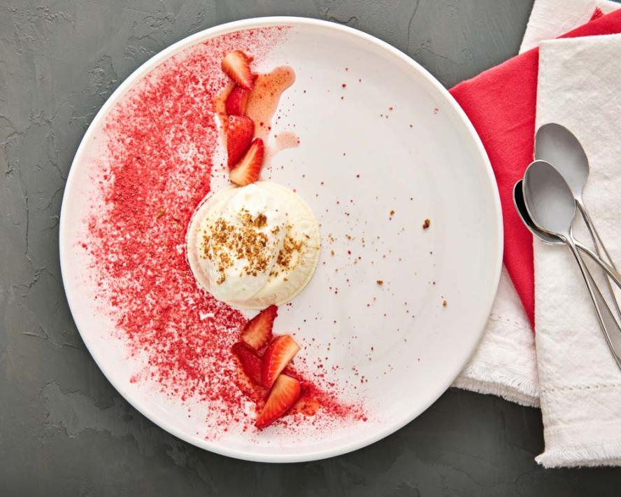 A plated dessert with strawberries 