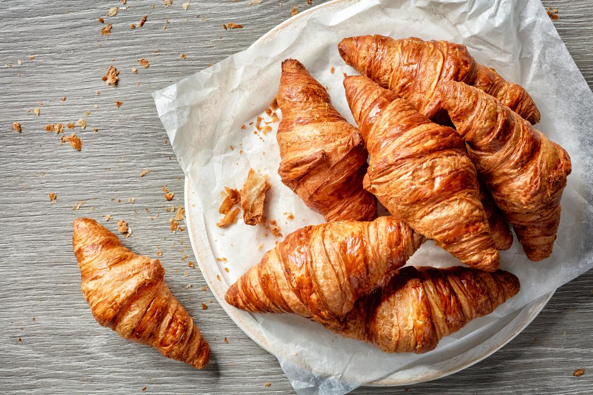 Freshly baked croissants served on a plate